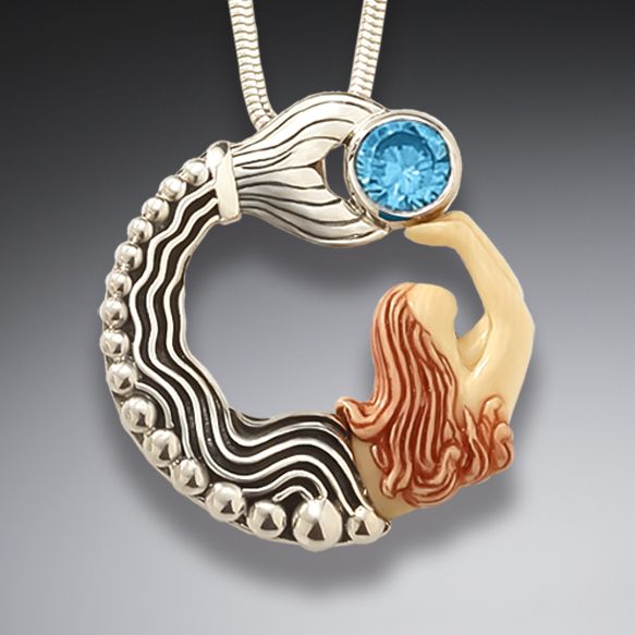 Fossilized mammoth ivory mermaid pendant with blue topaz